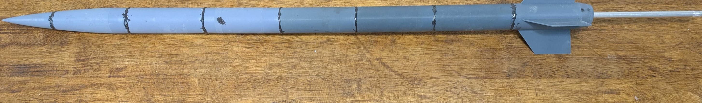 CAD-modeled rocket mounted for wind tunnel testing